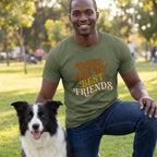 Man in an olive green "Dogs Are My Best Friends" t-shirt kneeling beside a black and white border collie.