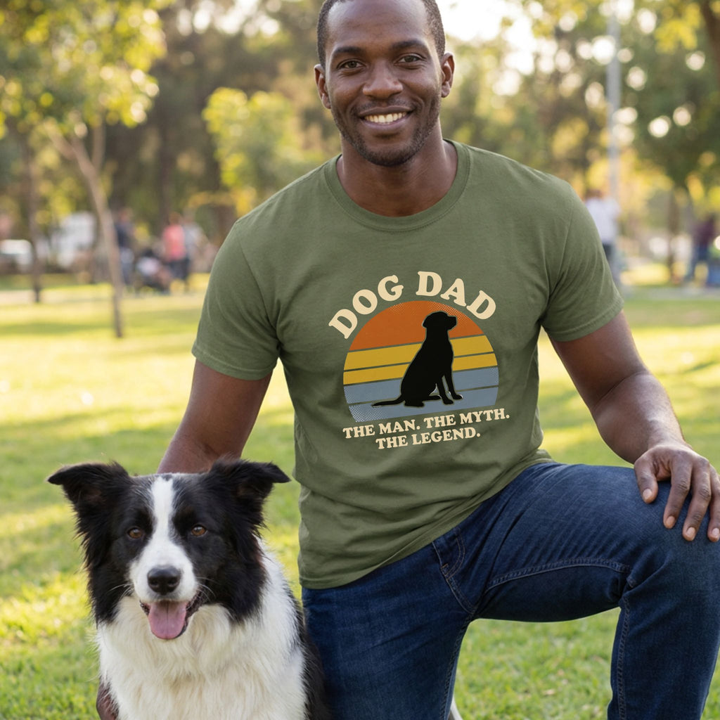 Man in olive green "Dog Dad" t-shirt with black dog silhouette, kneeling with a Border Collie.