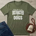 Olive green Gildan Softstyle® t-shirt with "Easily Distracted By Dogs" in white text, next to jeans and dog treats.