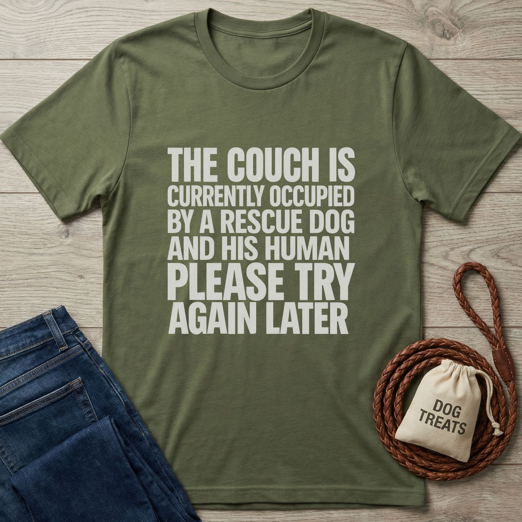 Olive green Gildan Softstyle t-shirt with "THE COUCH IS CURRENTLY OCCUPIED BY A RESCUE DOG AND HIS HUMAN PLEASE TRY AGAIN LATER" text.