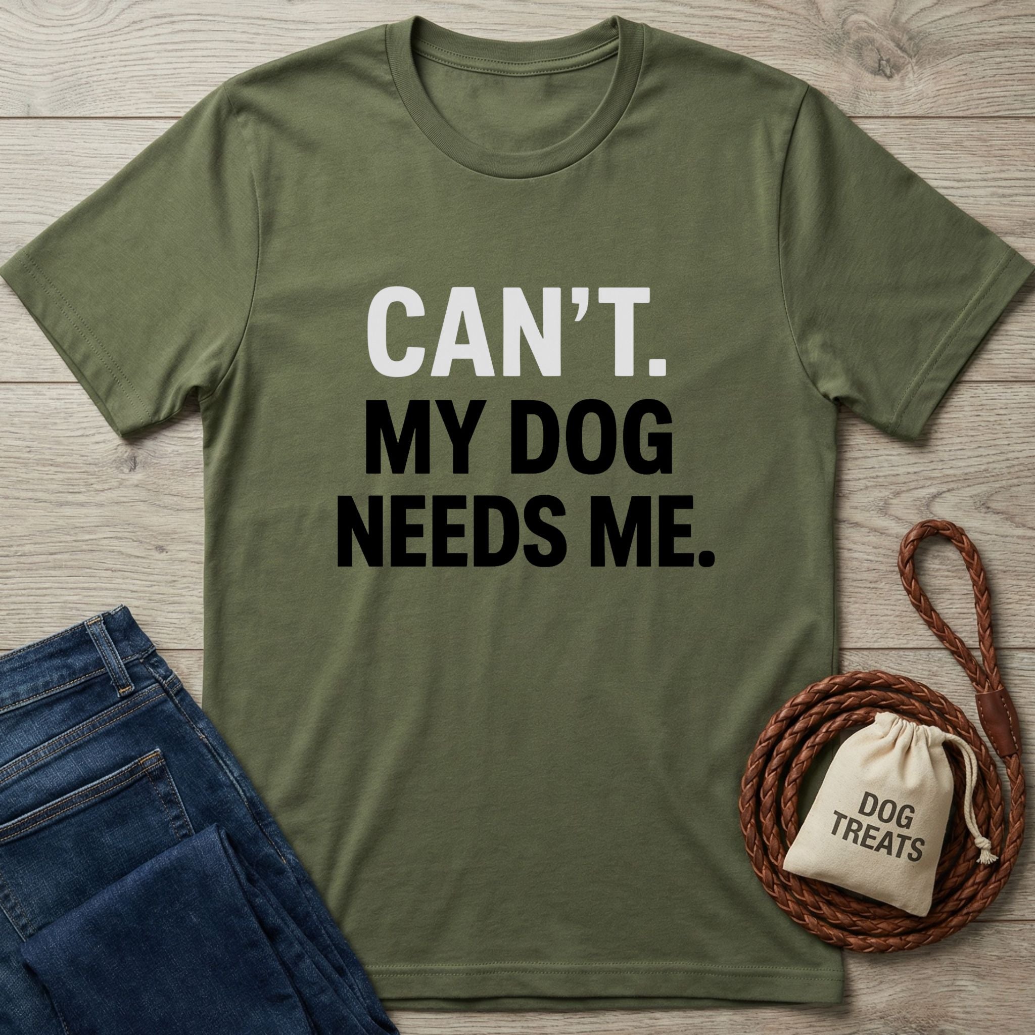 Olive green "Can't. My Dog Needs Me." t-shirt with jeans, leash, and treat bag.