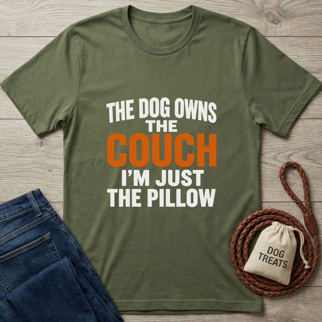 Olive green "The Dog Owns The Couch" t-shirt with jeans, a braided leash, and a "Dog Treats" bag.