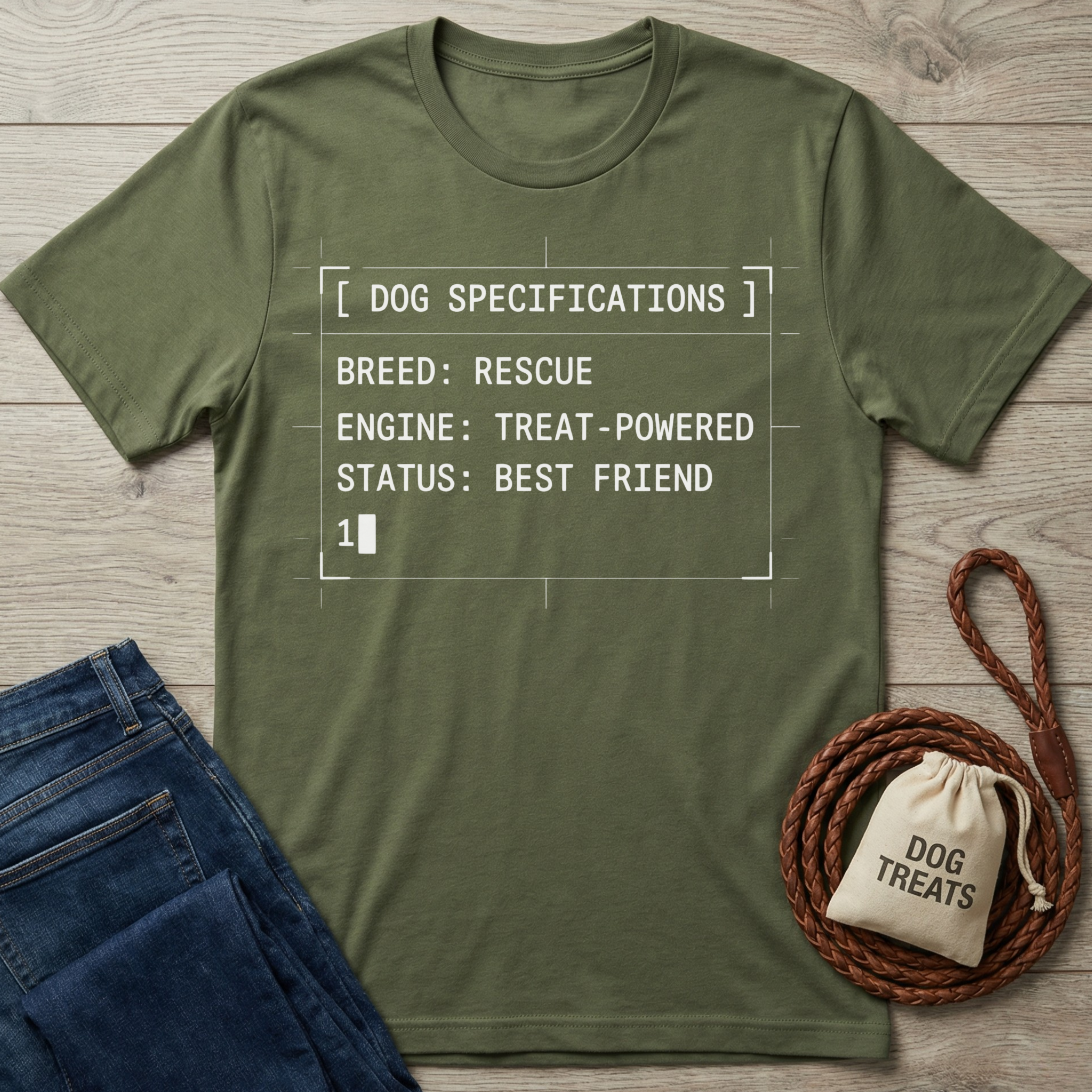 Olive green cotton t-shirt with "Dog Specifications" text, folded jeans, and a "Dog Treats" bag.