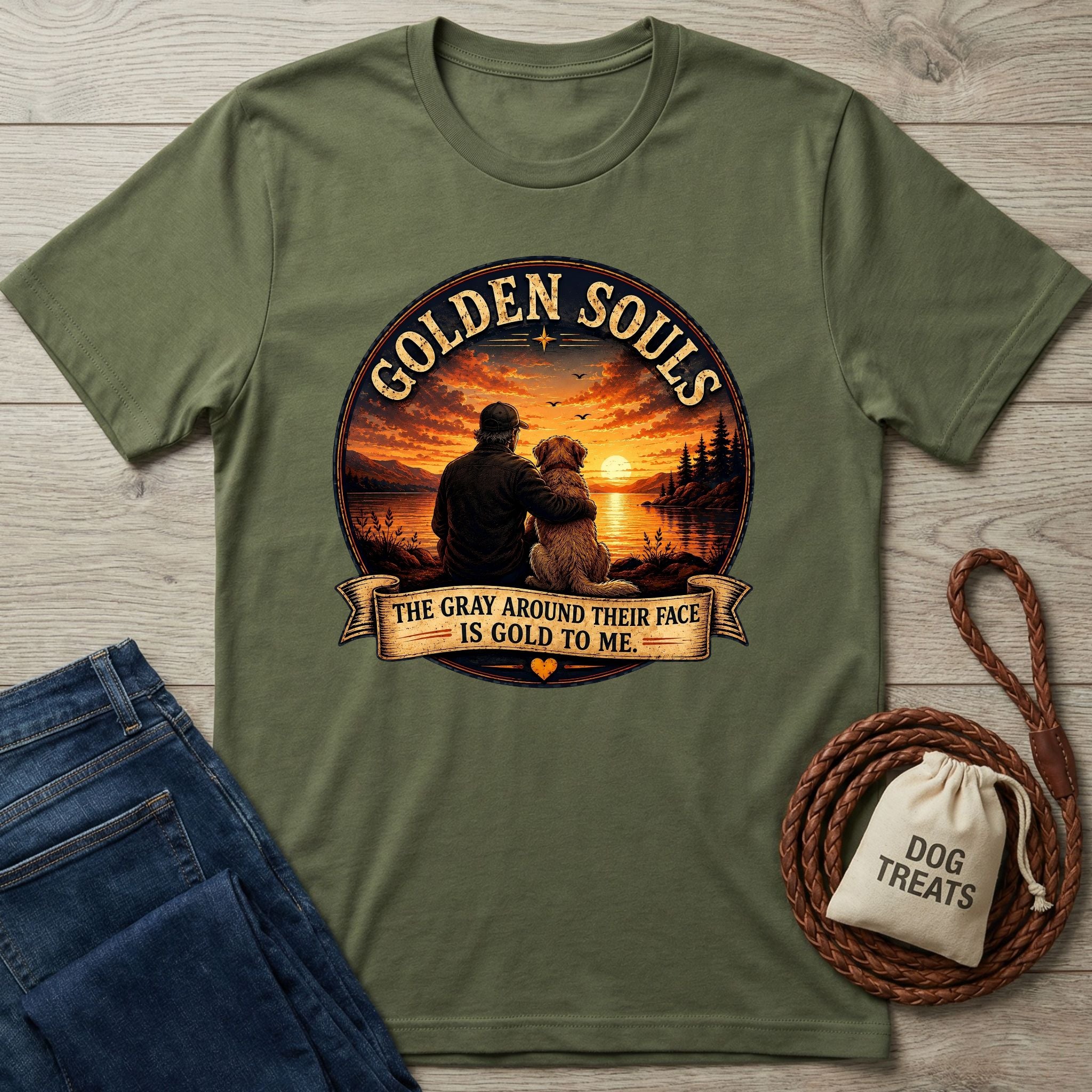 Olive green Golden Souls T-shirt with a graphic of a person hugging a senior dog at sunset.