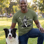 Man wearing an olive green crewneck t-shirt featuring a graphic of a dog in a witch hat holding a broomstick.