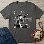 Charcoal grey crewneck t-shirt featuring a white graphic of a puppy in a witch hat holding a broomstick in a pumpkin patch.