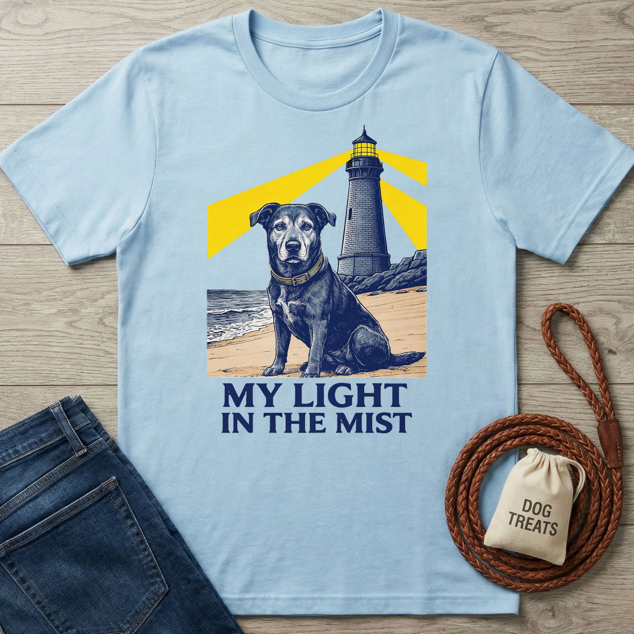 Light blue Gildan Softstyle® tee with a black rescue dog and lighthouse graphic, "MY LIGHT IN THE MIST" text.