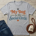 Grey crewneck t-shirt featuring My Dog Is My Social Circle text in retro orange and blue with a paw print and heart.