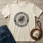 Cream Gildan Softstyle® T-shirt with "Perfectly Imperfect Rescue Strong" graphic featuring a running dog, next to jeans and a treat bag.