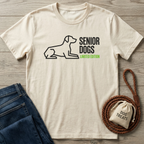 Cream cotton t-shirt with black "SENIOR DOGS" text, green "LIMITED EDITION," and a minimalist dog outline.