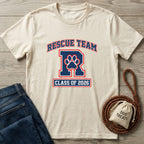Cream Gildan Softstyle® "Rescue Team R Class of 2026" tee with dog paw print, next to jeans and dog treats.