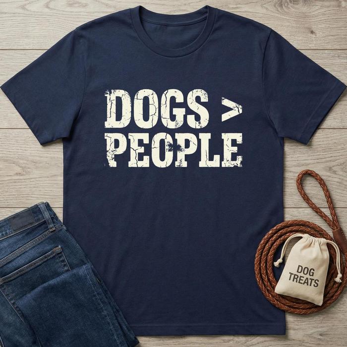 Navy blue cotton t-shirt with distressed white "DOGS > PEOPLE" text, next to jeans and dog treats.