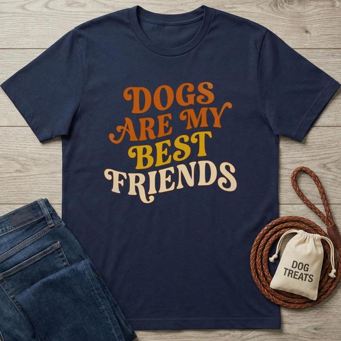 Navy cotton "Dogs Are My Best Friends" t-shirt with orange and yellow text, next to jeans and dog treats bag.