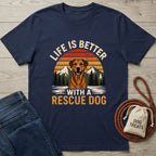 Navy blue Gildan Softstyle® t-shirt with "Life is Better With A Rescue Dog" graphic, jeans, and dog treats.