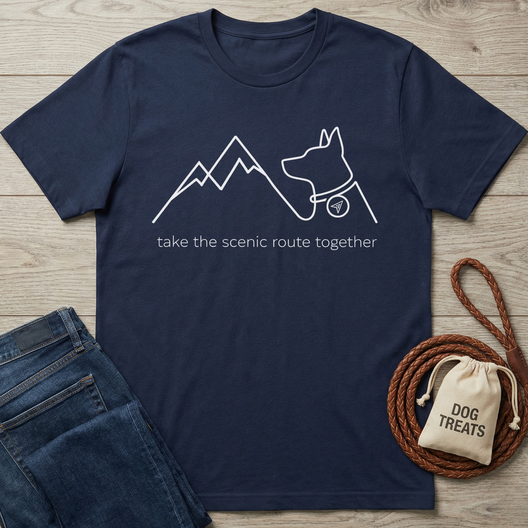 Navy cotton t-shirt with white outline graphic of mountains and a dog, text "take the scenic route together".