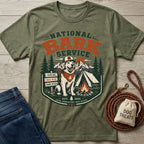 Olive green crewneck t-shirt featuring a National Bark Service graphic with a dog, camping gear, and mountains.