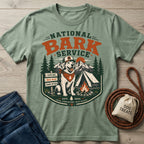 Sage green crewneck t-shirt featuring a National Bark Service graphic with a dog, tent, and campfire print.