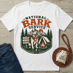 White crewneck t-shirt featuring a National Bark Service graphic with a dog in a hat, campfire, and mountain landscape.
