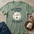 Sage green crewneck t-shirt featuring a graphic of a sleepy dog in a teacup with the text Not A Morning Person Just A Dog Person.