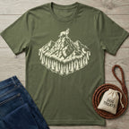 Olive green cotton t-shirt with a cream graphic of a dog on a mountain peak surrounded by pine trees.