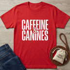 Red Gildan Softstyle® 64000 t-shirt with "Caffeine & Canines" in white, next to jeans and dog treats.