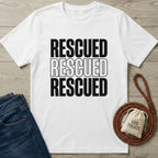White Gildan Softstyle® "Rescued" graphic tee, dark jeans, braided leash, and "Dog Treats" bag.