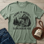 Sage green Gildan Softstyle® t-shirt with "Home Is Where The Rescue Is" graphic featuring a dog on a porch.