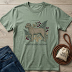 Sage green Rescue Specimen T-shirt with a detailed dog illustration, ferns, berries, and "Field Notes: Canis Familiaris - Rescue Specimen" text.