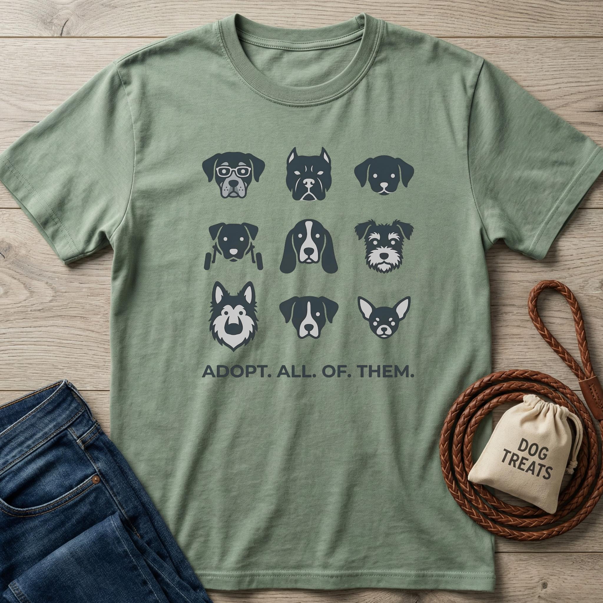 Sage green cotton t-shirt with nine dark gray dog breed head illustrations and "ADOPT. ALL. OF. THEM." text.