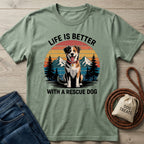 Sage green Gildan Softstyle tee with "Life is Better With a Rescue Dog" text and a happy dog in a mountain sunset graphic.