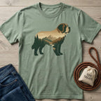 Sage green "Mountain Dog" T-shirt with a St. Bernard silhouette filled with a forest and mountain landscape.