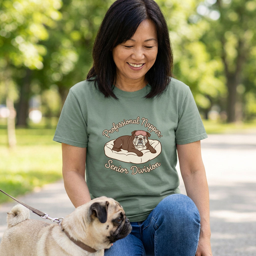 Woman in an olive green "Professional Napper Senior Division" t-shirt with a bulldog graphic, next to a pug.