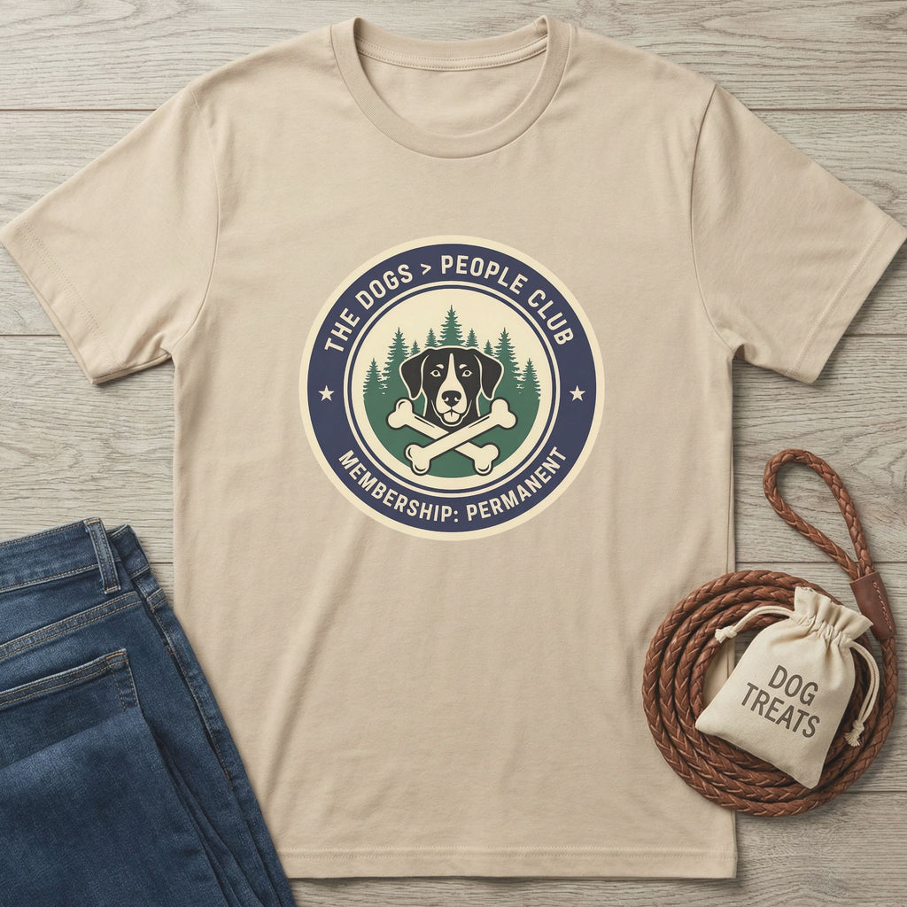 Beige Gildan Softstyle® t-shirt with "The Dogs > People Club" graphic, blue jeans, and dog treats bag.