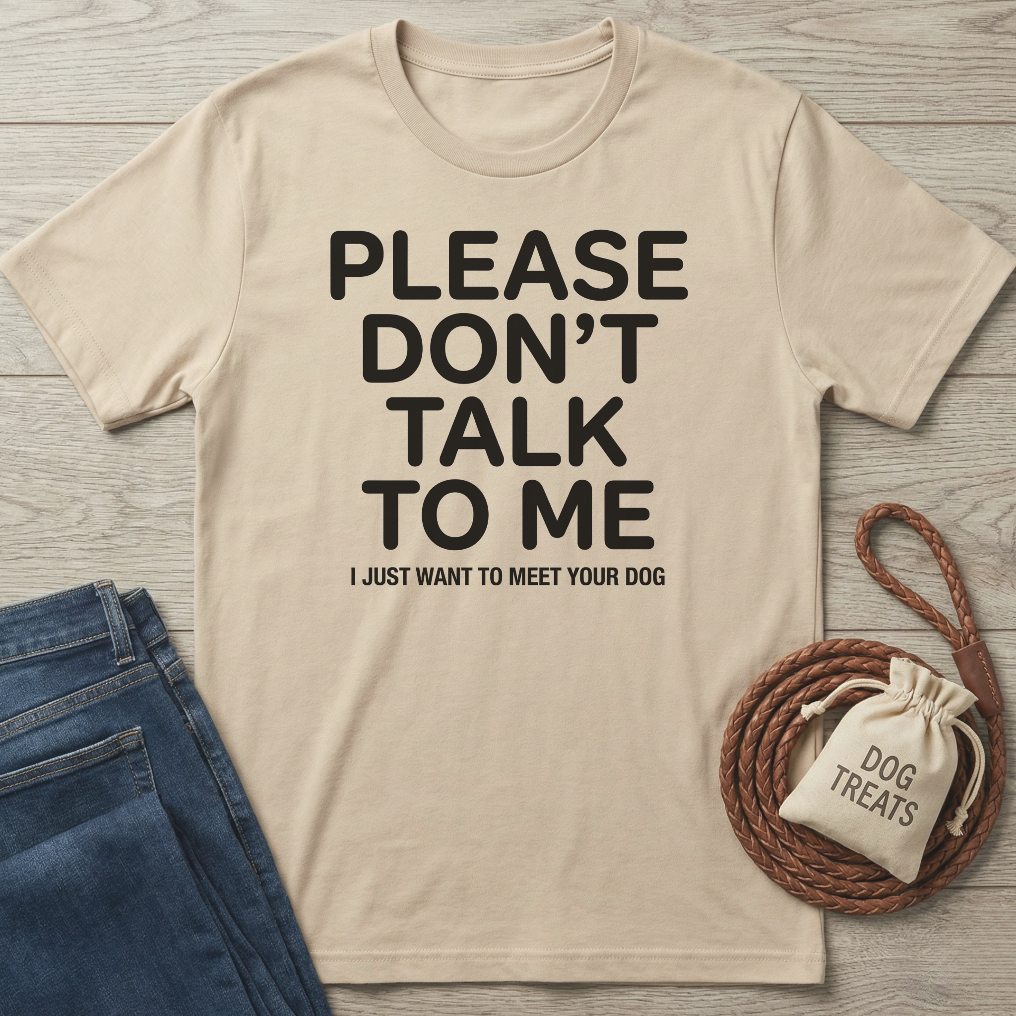 Beige cotton t-shirt with "PLEASE DON'T TALK TO ME I JUST WANT TO MEET YOUR DOG" text.