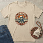 Rescue Dog Adventure Club t-shirt in natural, 100% ring-spun cotton, featuring a circular graphic with a dog, mountains, and "Loyalty First.