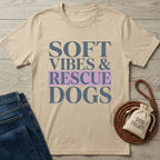 Beige Gildan Softstyle t-shirt with "SOFT VIBES & RESCUE DOGS" in blue and purple text.