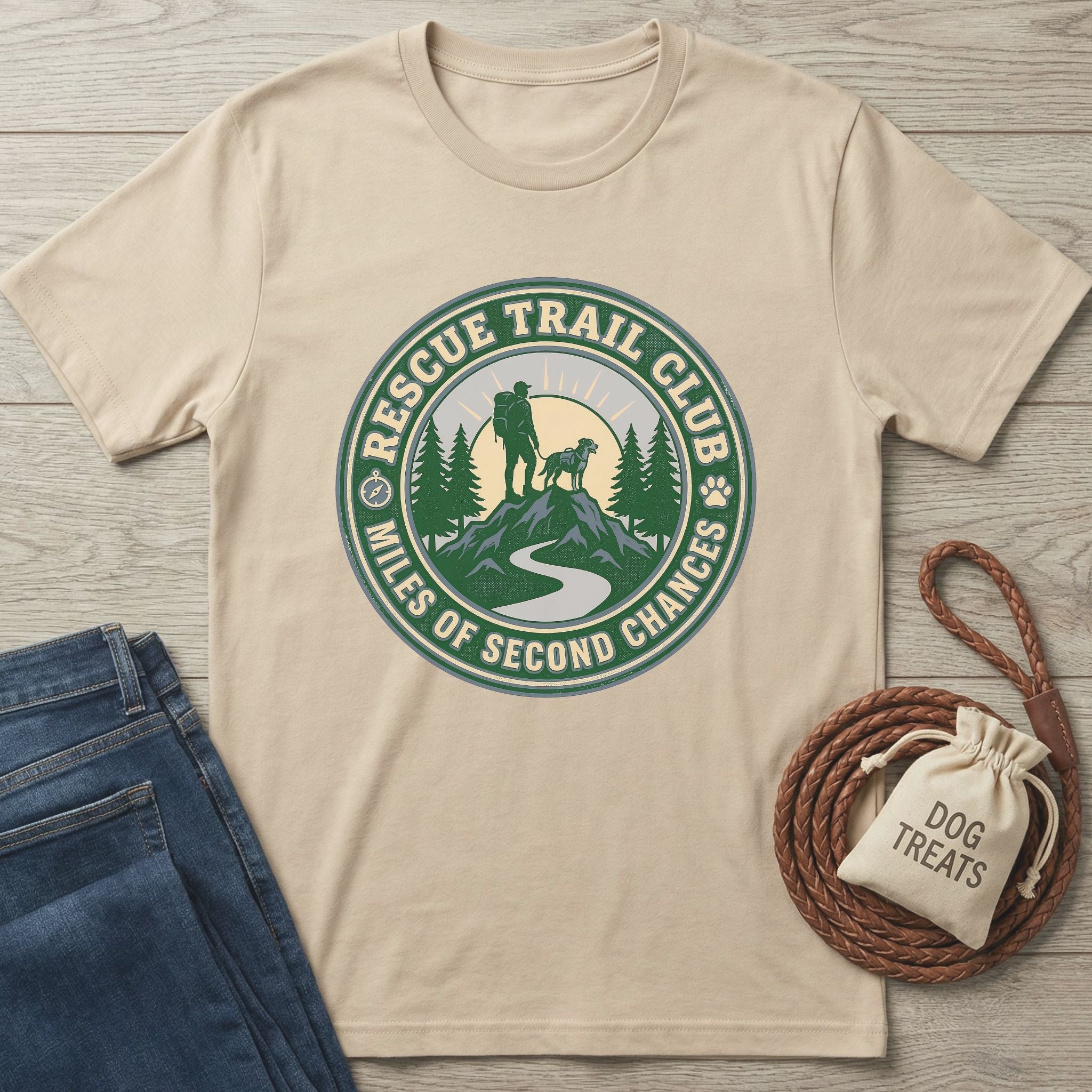 Rescue Trail Club T-shirt in natural, featuring a graphic of a hiker and dog on a mountain trail.