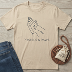 Beige cotton t-shirt with "Prayers & Paws" text and praying hands with a paw print design.