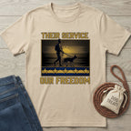 Beige Gildan Softstyle t-shirt with "Their Service Our Freedom" graphic featuring a soldier and dog.