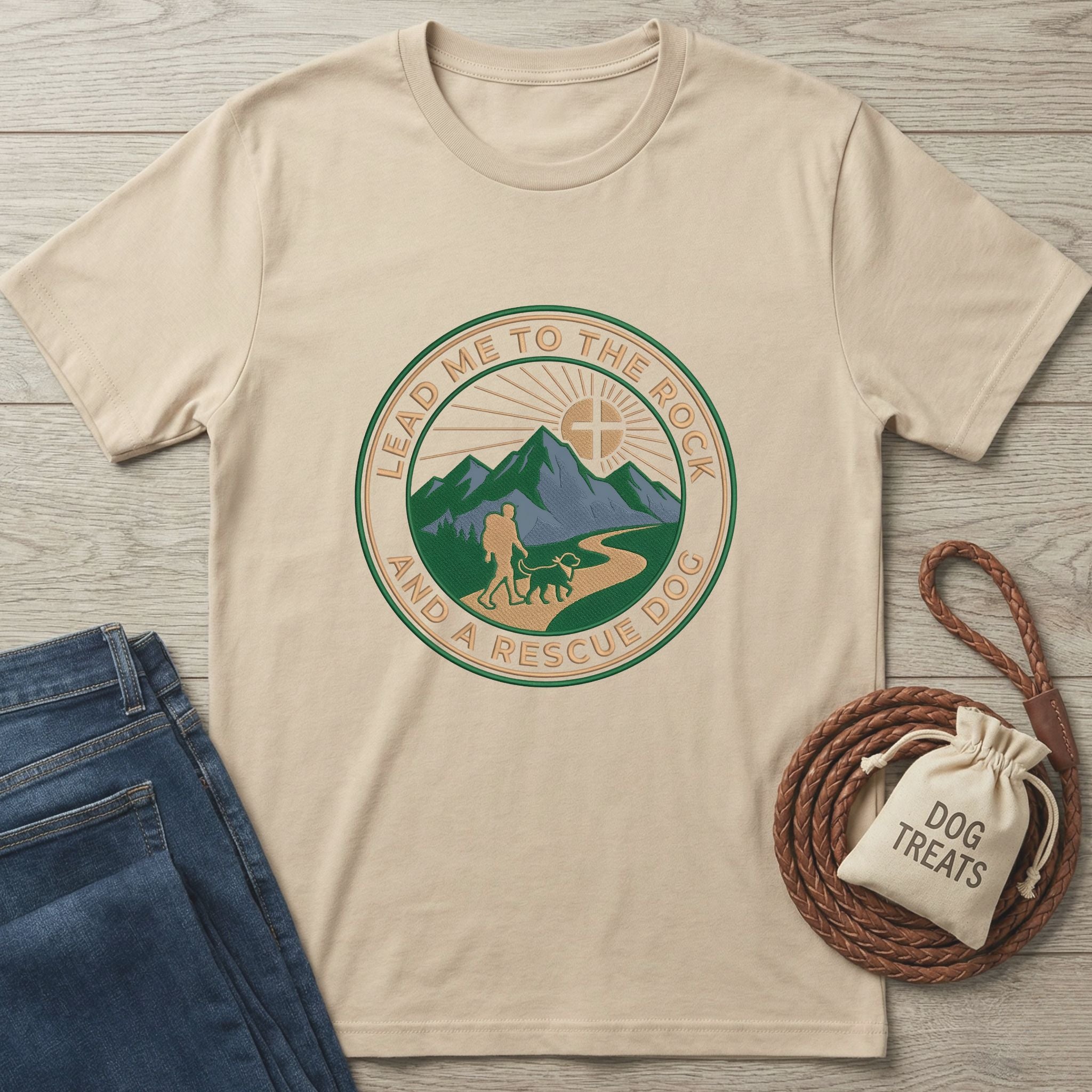 Beige Gildan Softstyle t-shirt with "Lead Me To The Rock And A Rescue Dog" graphic, jeans, and dog treats.