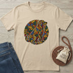 Beige t-shirt with colorful dog graphic, blue jeans, and dog treats bag on a wooden surface