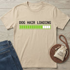 Beige cotton t-shirt with "DOG HAIR LOADING" text and a green progress bar, next to jeans and a treat bag.