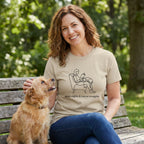 Woman in a tan "Quiet Nights & Rescue Snuggles" tee, petting a dog on a park bench.