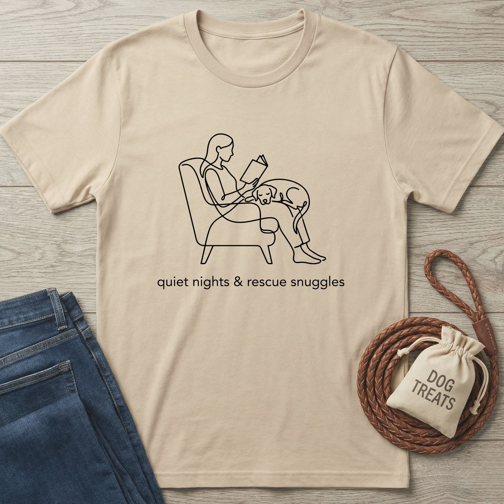 Beige Gildan Softstyle® t-shirt with "quiet nights & rescue snuggles" and line art of a person reading with a dog.