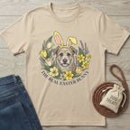 Beige Gildan Softstyle® t-shirt with a dog wearing bunny ears in a floral wreath, "The Real Easter Bunny" text.