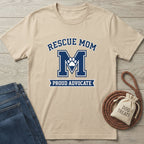 Tan Gildan Softstyle® t-shirt with "Rescue Mom M Proud Advocate" design and paw print.