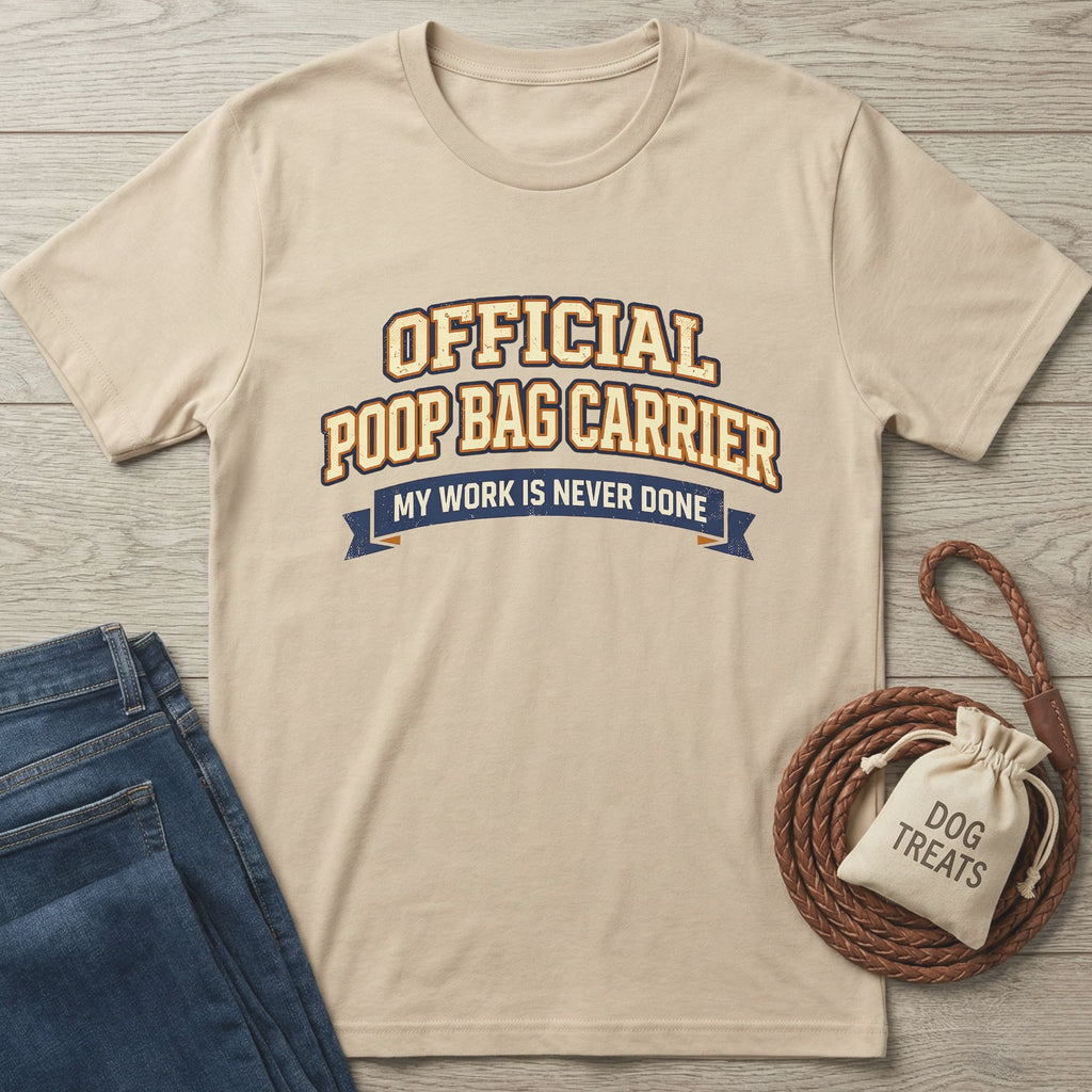 Tan Gildan Softstyle® t-shirt with "Official Poop Bag Carrier" text, next to jeans and dog treats.