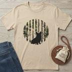 Beige t-shirt with a black dog silhouette against a striped camo and forest design.
