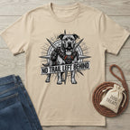 Beige Gildan Softstyle t-shirt with a graphic of a pit bull in a harness and "NO TRAIL LEFT BEHIND" text.