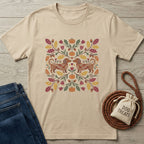 Beige Gildan Softstyle t-shirt with two dachshunds, pumpkins, and autumn leaves design, next to jeans and dog treats.